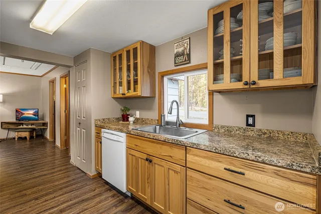 a kitchen with stainless steel appliances granite countertop a sink and cabinets