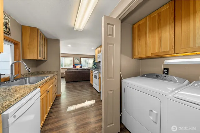a kitchen that has a sink and a stove in it