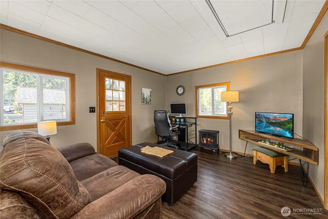 a living room with furniture and a flat screen tv with wooden floor