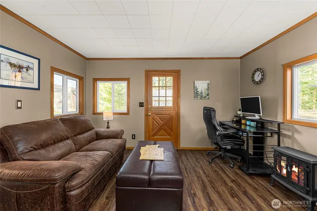 a living room with furniture a piano and a flat screen tv
