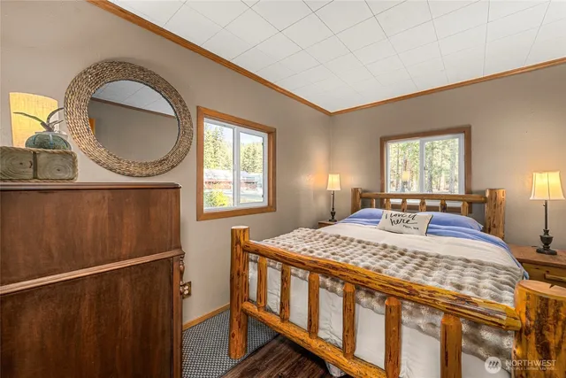 a bedroom with a bed a mirror and window