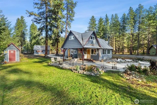 a view of house with backyard outdoor seating and green space