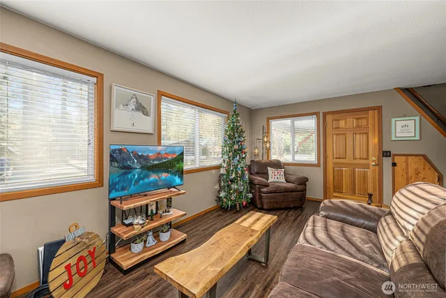 a bedroom with furniture and a large window