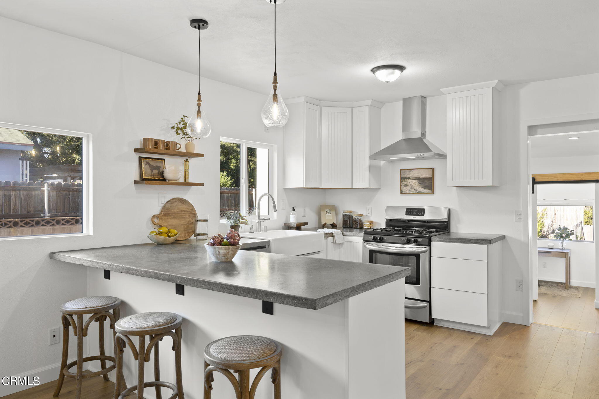 370 Prospect Street Oak View, CA 93022 - Photo 11 of 46 a kitchen with stainless steel appliances granite countertop a stove a sink a refrigerator a stove a dining table and chairs with wooden floor