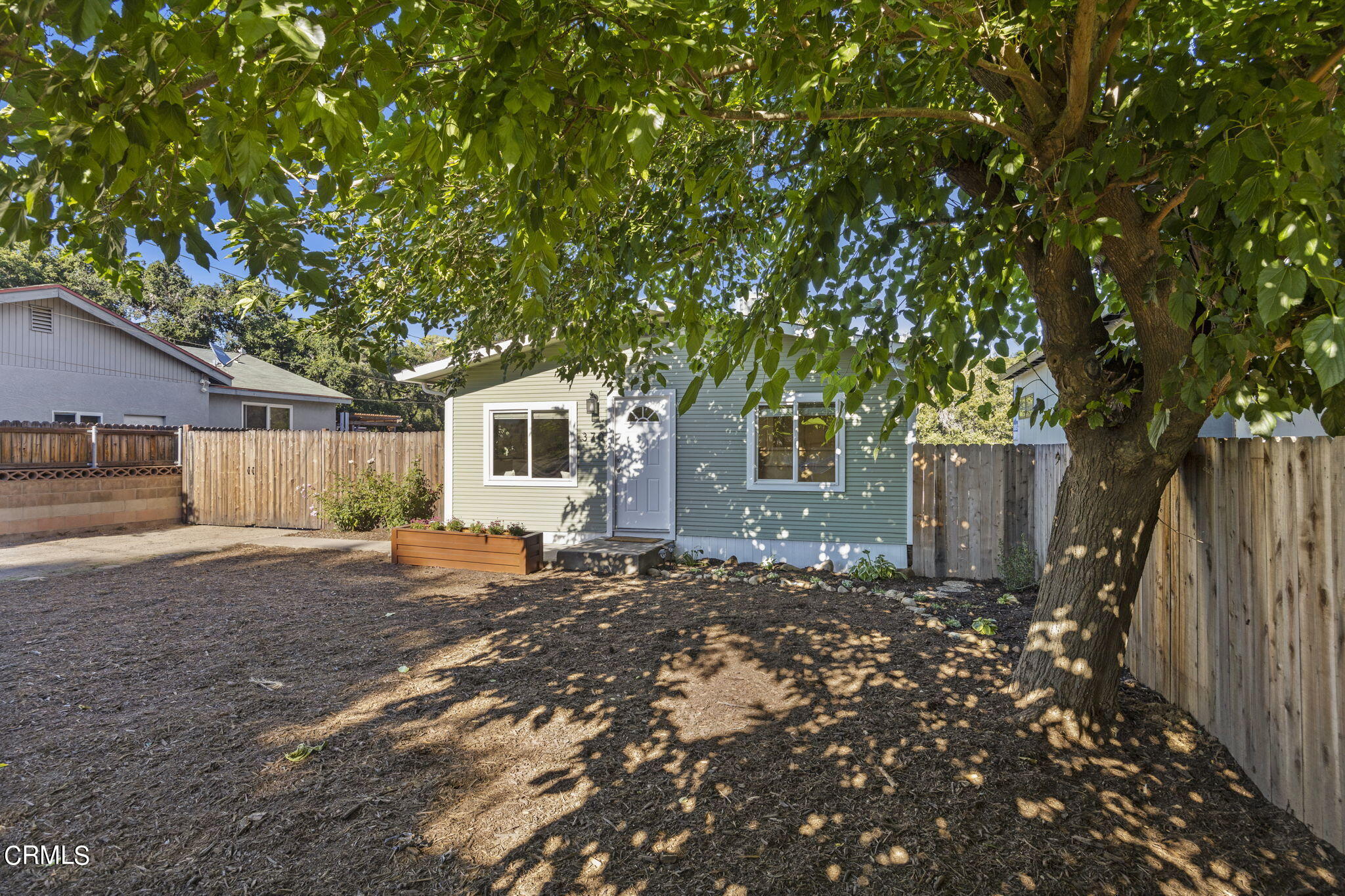 370 Prospect Street Oak View, CA 93022 - Photo 3 of 46 a backyard of a house with table and chairs