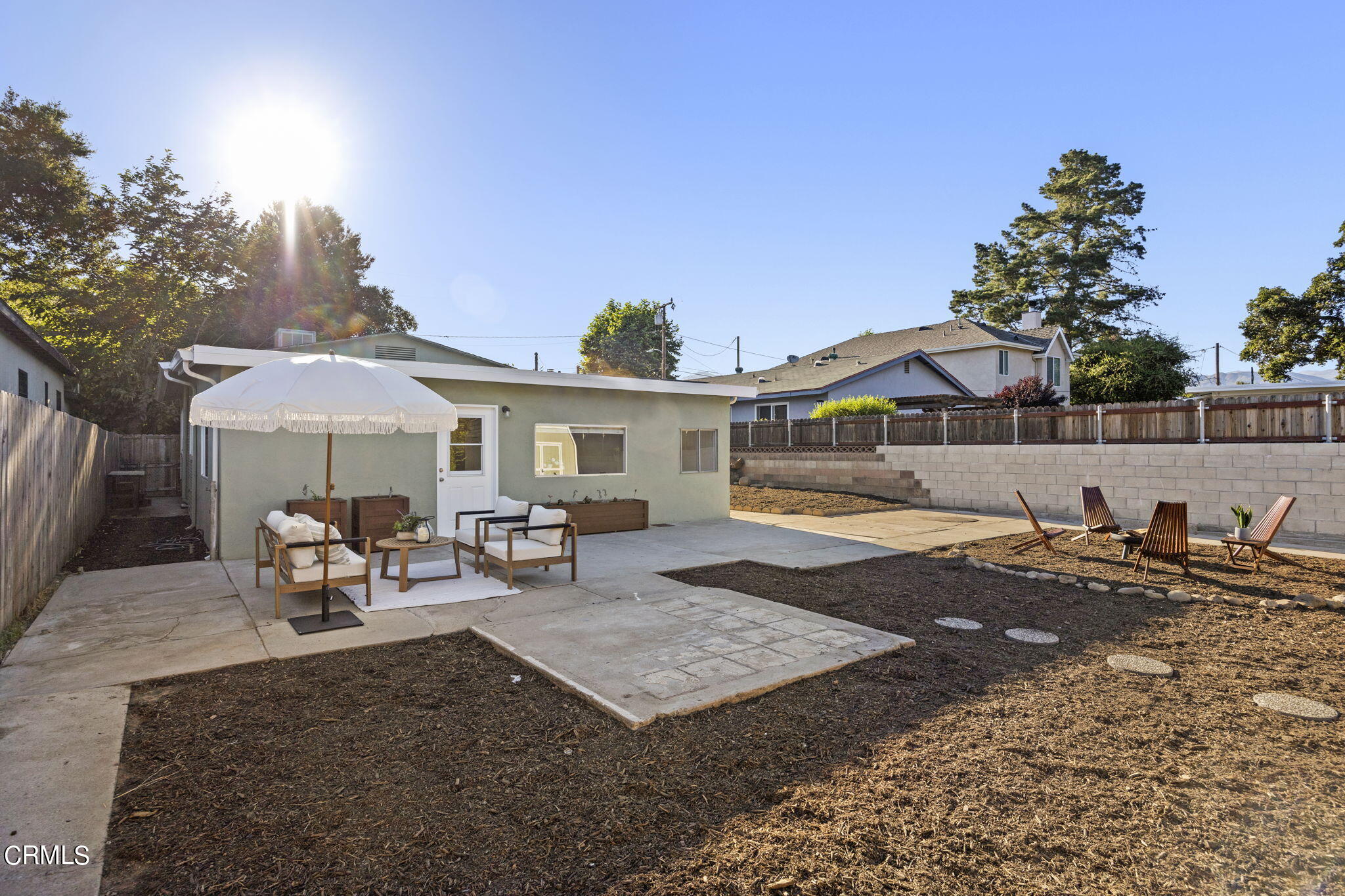 370 Prospect Street Oak View, CA 93022 - Photo 34 of 46 a view of a patio with table and chairs under an umbrella with large trees