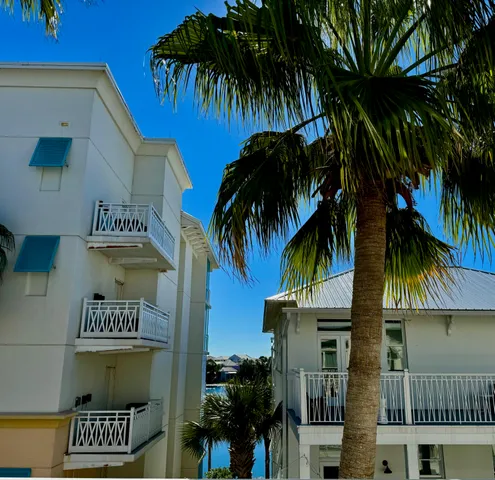 a front view of multi story residential apartment building with yard and sign board