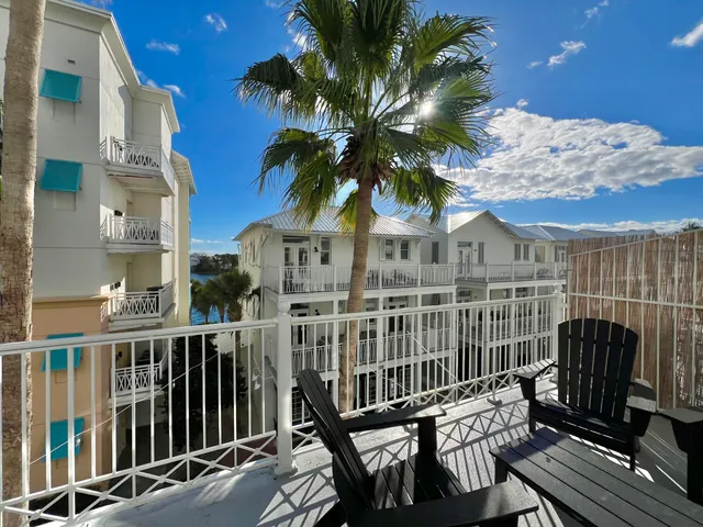 a view of a balcony with a potted plant and wooden fence