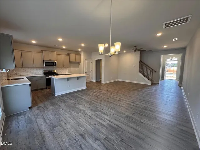 a view of wooden floor and windows in a room