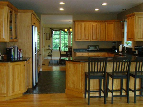 5 Gray Road Andover, MA 01810 - Photo 5 of 22 a kitchen with stainless steel appliances kitchen island granite countertop a refrigerator a stove and a sink with wooden floor