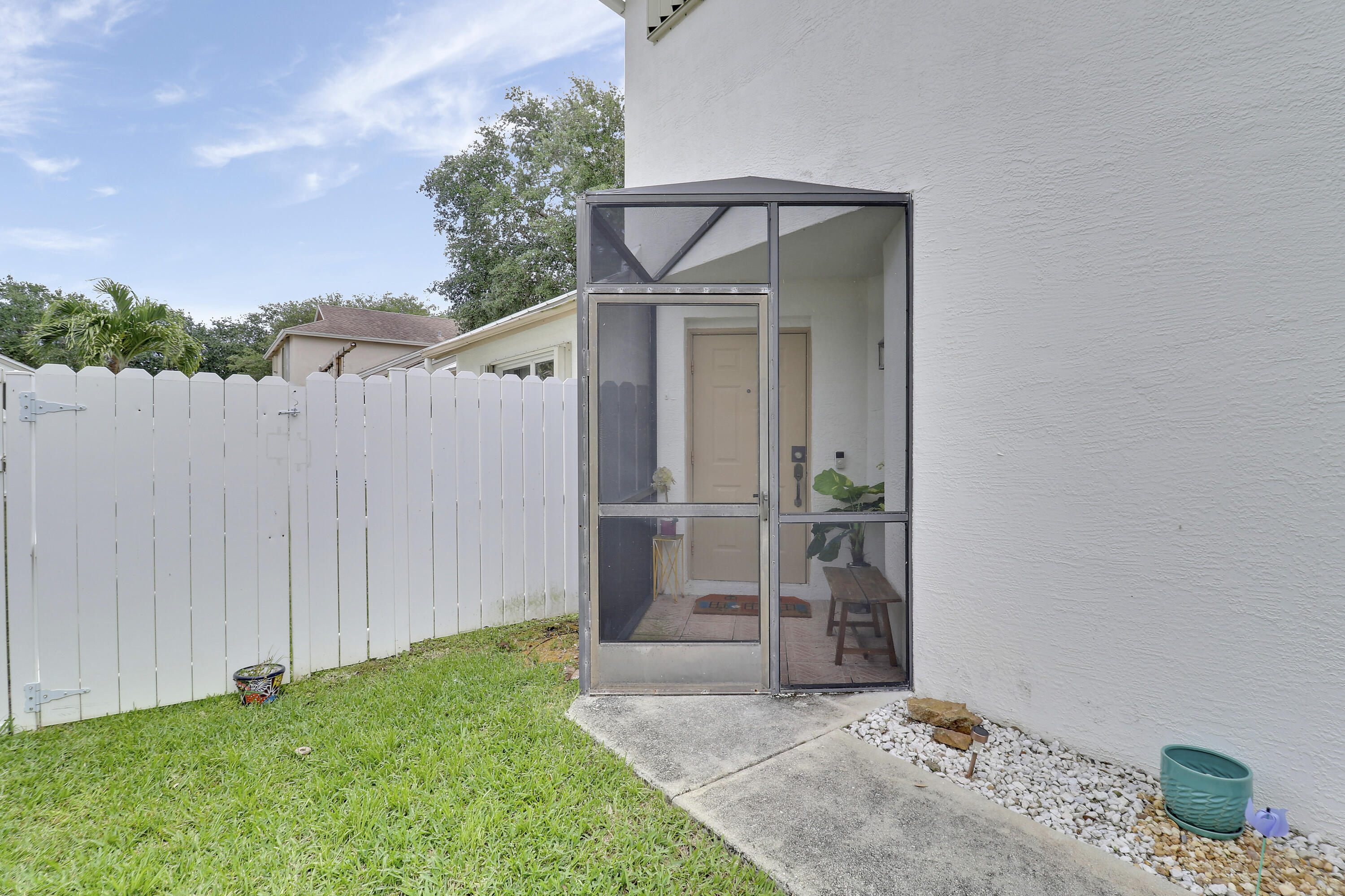 144 Pennock Landing Circle Jupiter, FL 33458 - Photo 16 of 34 a view of a wooden door and a yard