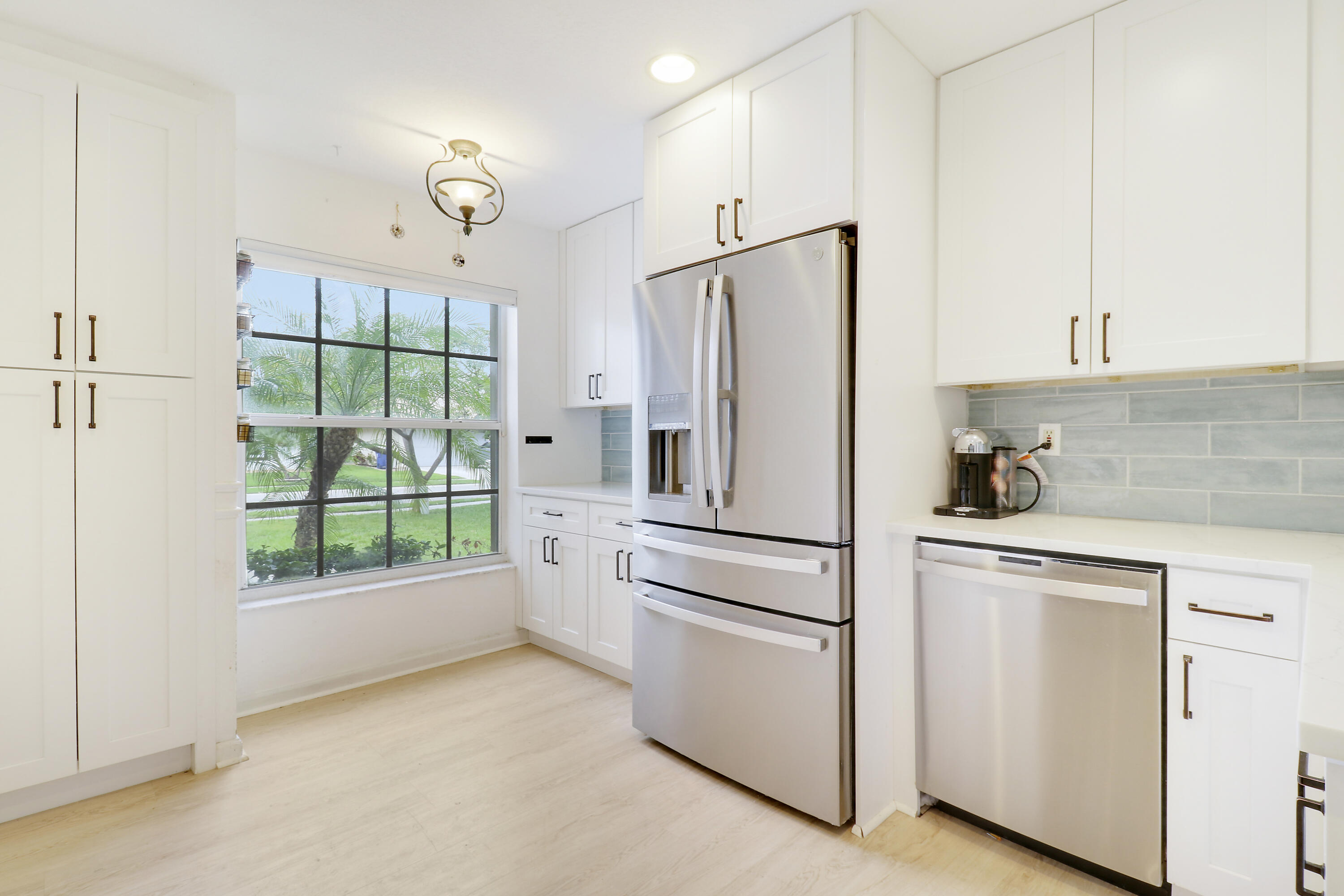 144 Pennock Landing Circle Jupiter, FL 33458 - Photo 2 of 34 a white refrigerator freezer and a stove sitting inside of a kitchen