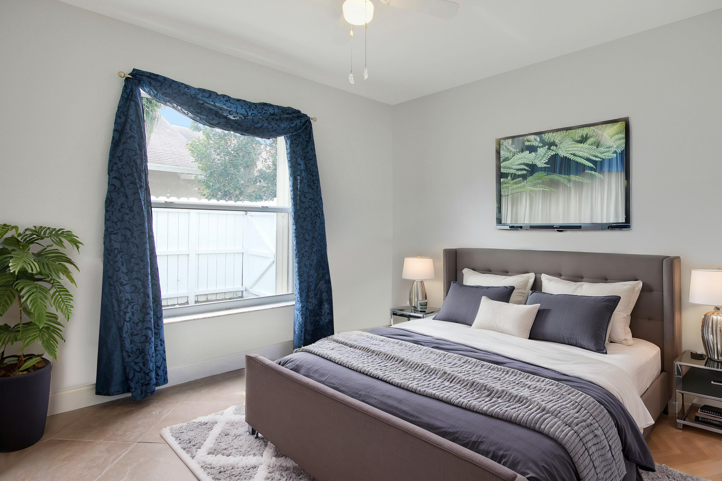 144 Pennock Landing Circle Jupiter, FL 33458 - Photo 28 of 34 a bedroom with a bed and a painting on the wall