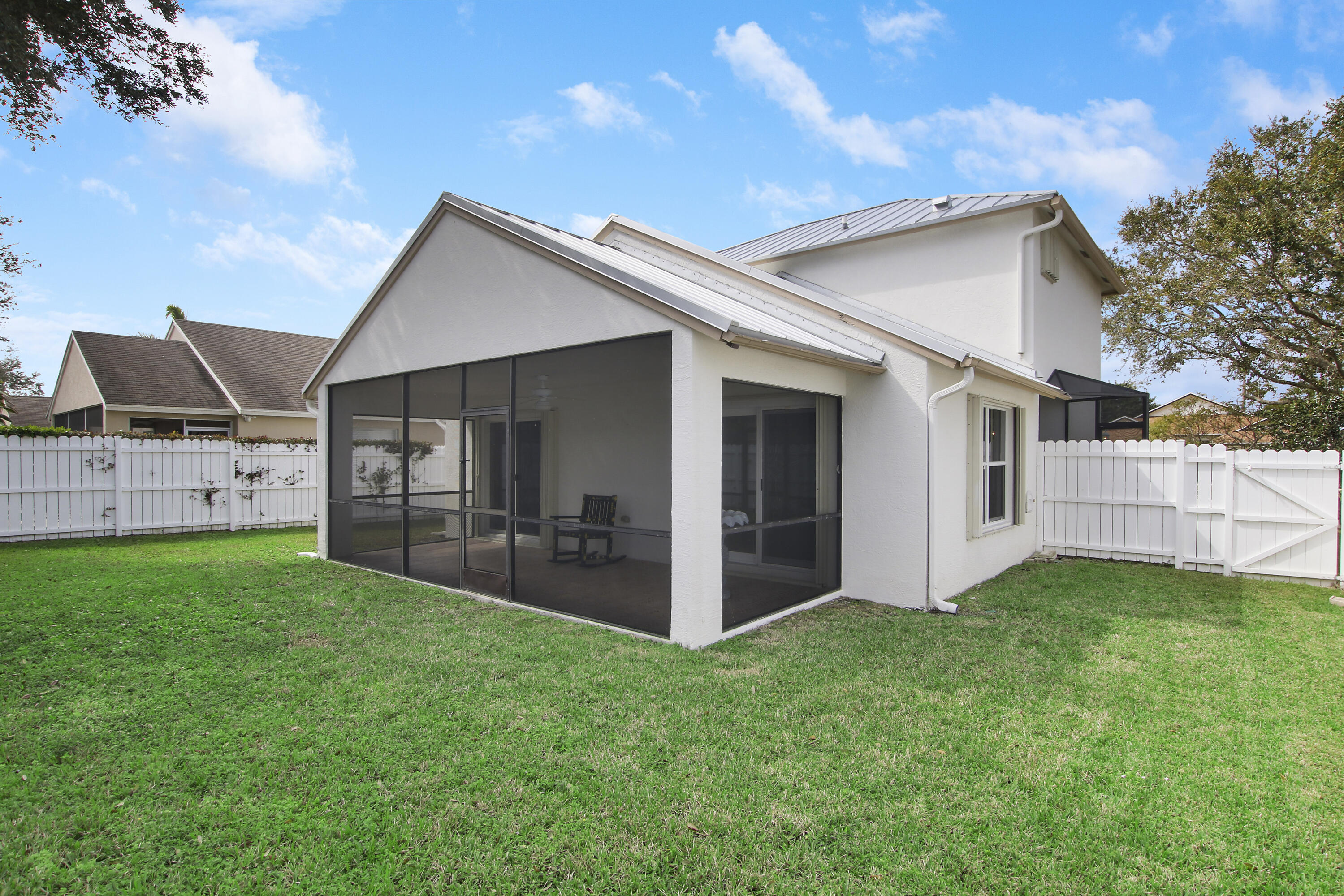 144 Pennock Landing Circle Jupiter, FL 33458 - Photo 33 of 34 a view of a house with a yard and porch