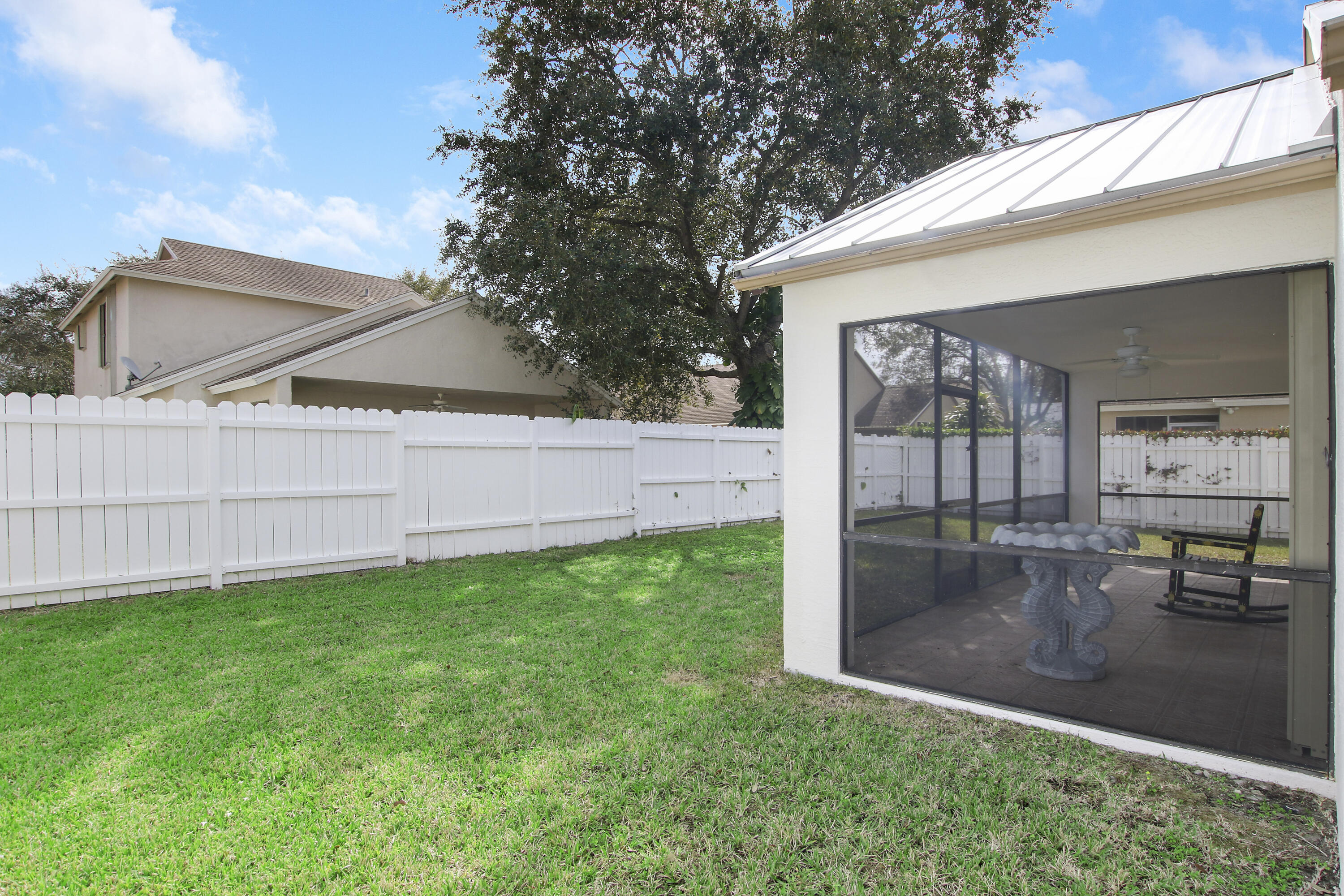 144 Pennock Landing Circle Jupiter, FL 33458 - Photo 34 of 34 a backyard of a house with table and chairs
