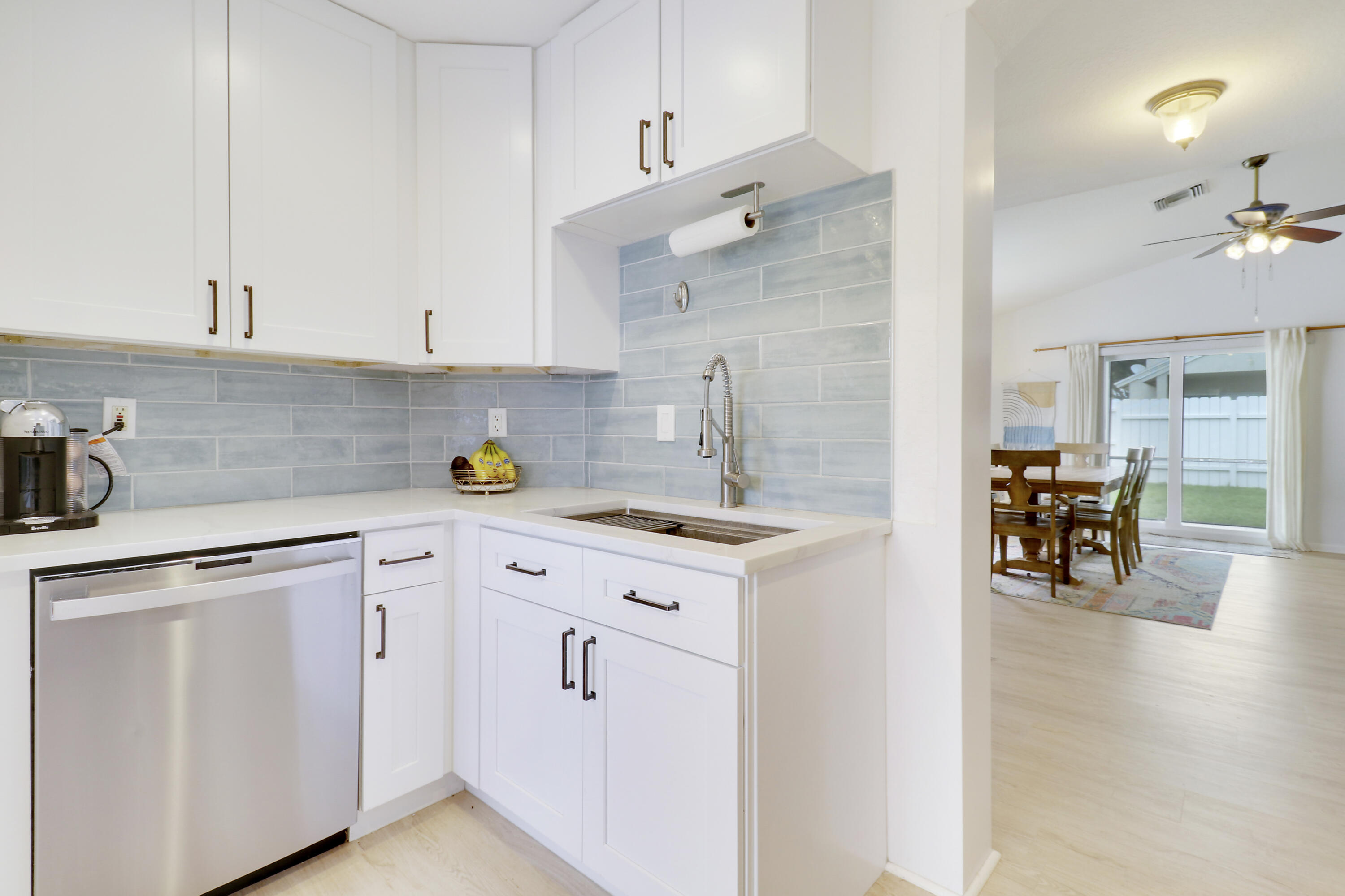 144 Pennock Landing Circle Jupiter, FL 33458 - Photo 4 of 34 a kitchen with cabinets and chairs