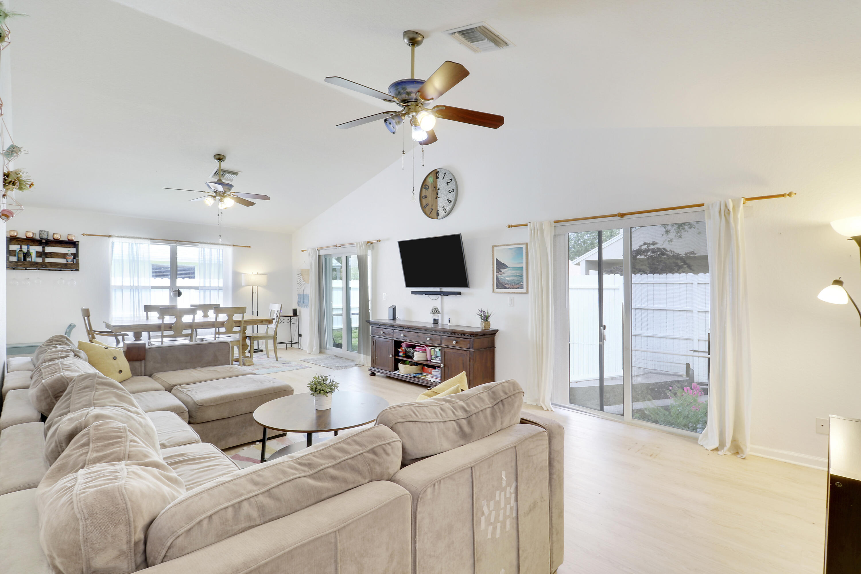 144 Pennock Landing Circle Jupiter, FL 33458 - Photo 5 of 34 a living room with furniture a fireplace and a flat screen tv