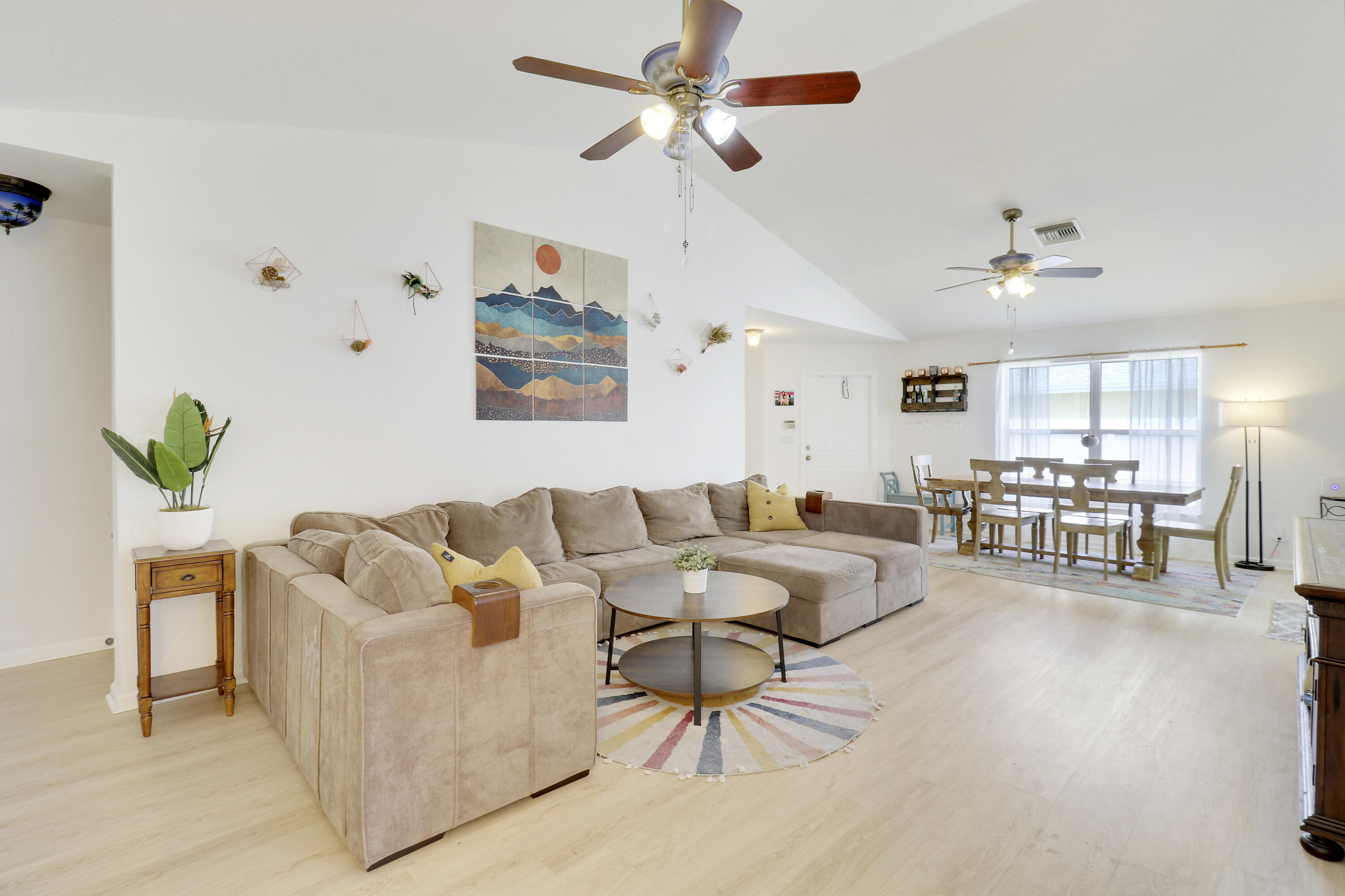 144 Pennock Landing Circle Jupiter, FL 33458 - Photo 7 of 34 a living room with furniture and a chandelier