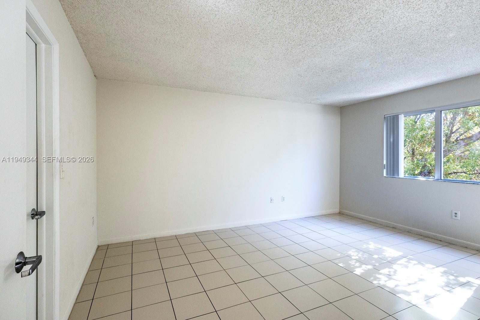 2660 Southwest 37th Avenue, Unit 314 Miami, FL 33133 - Photo 6 of 12 a view of an empty room and window