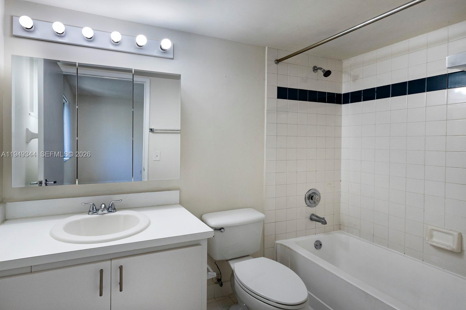 2660 Southwest 37th Avenue, Unit 314 Miami, FL 33133 - Photo 10 of 12 a bathroom with a sink and a mirror