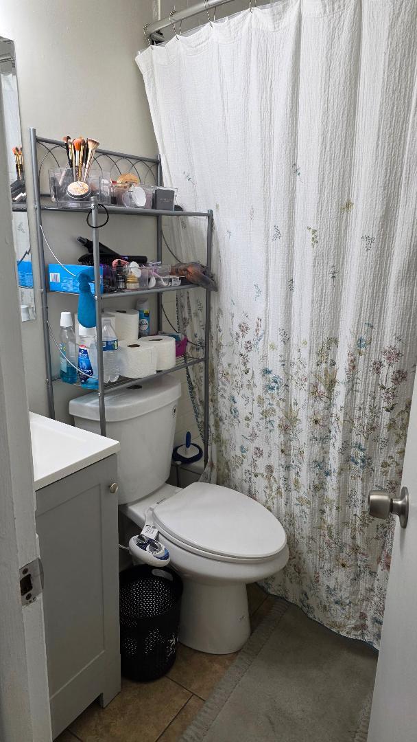 10 Arrowhead Drive, Unit 2 Algonquin, IL 60102 - Photo 4 of 8 a bathroom with a toilet and a shower curtain