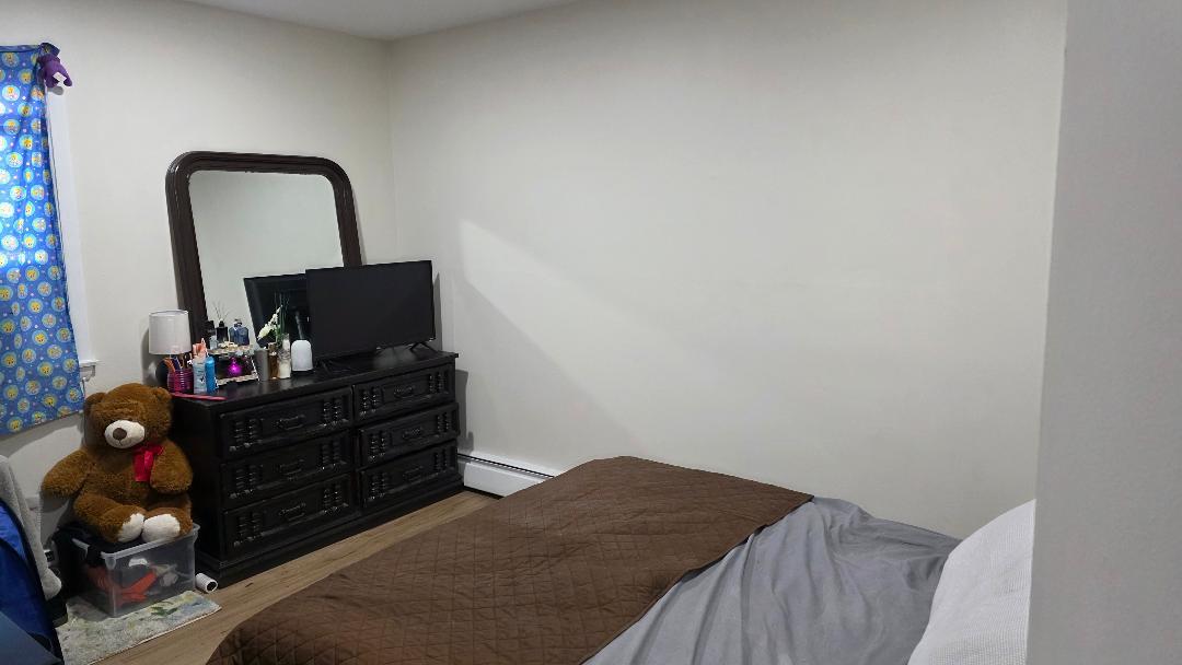 10 Arrowhead Drive, Unit 2 Algonquin, IL 60102 - Photo 5 of 8 a bed sitting in a bedroom next to a window