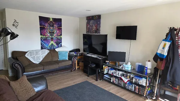a living room with furniture and a flat screen tv