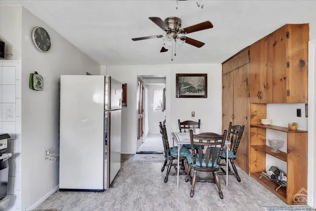 a living room with furniture a dining table and chairs