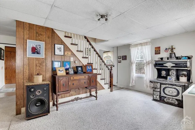 a view of a livingroom with furniture and a window