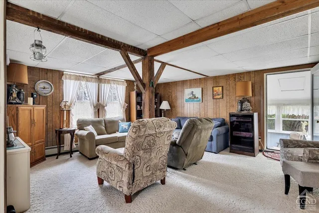 a living room with furniture a window and a chandelier