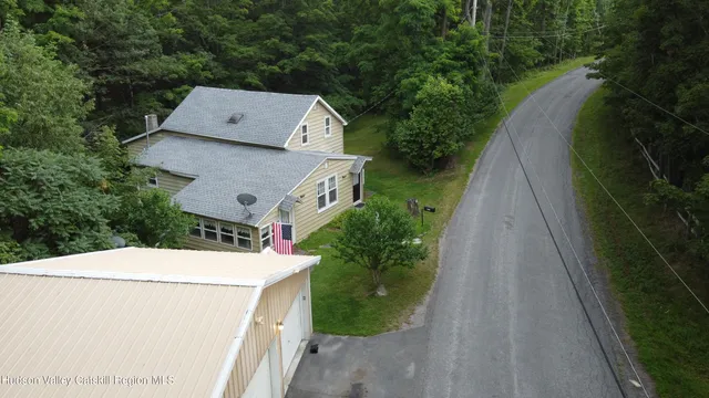 an aerial view of a house with a yard and garden