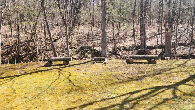 a view of kitchen with stainless steel appliances kitchen island granite countertop refrigerator stove and sink