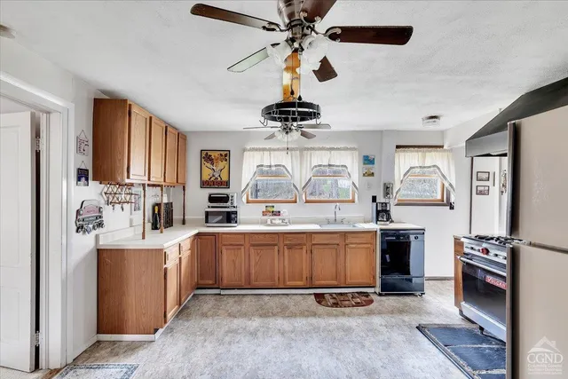 a kitchen with stainless steel appliances a stove a sink and a microwave