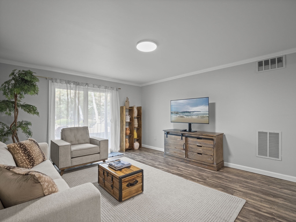 7 Shadowbrook Lane, Unit 9 Milford, MA 01757 - Photo 1 of 41 a living room with furniture and a window