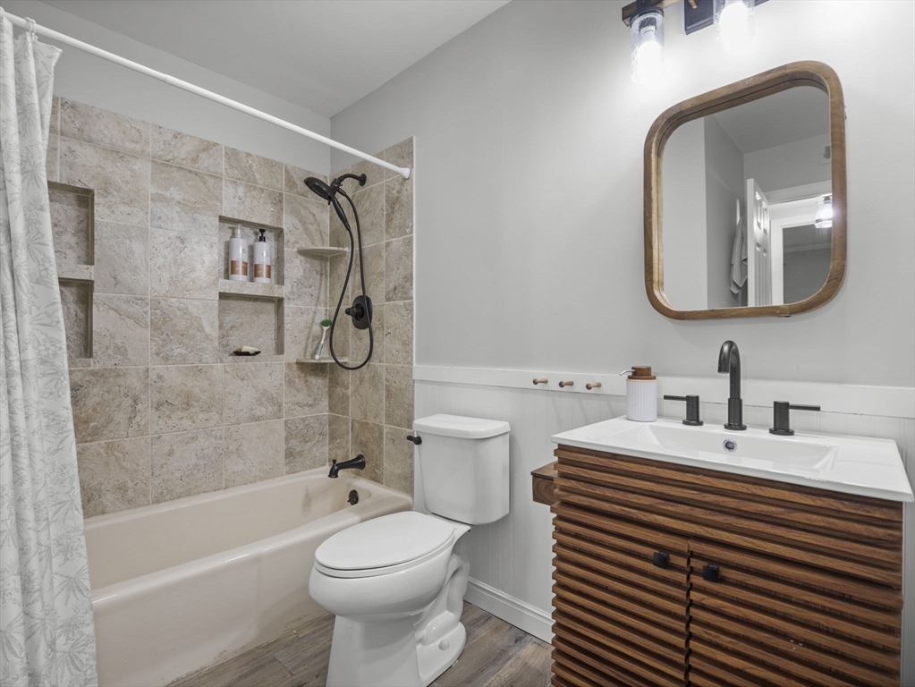 7 Shadowbrook Lane, Unit 9 Milford, MA 01757 - Photo 12 of 41 a bathroom with a sink a toilet and a mirror