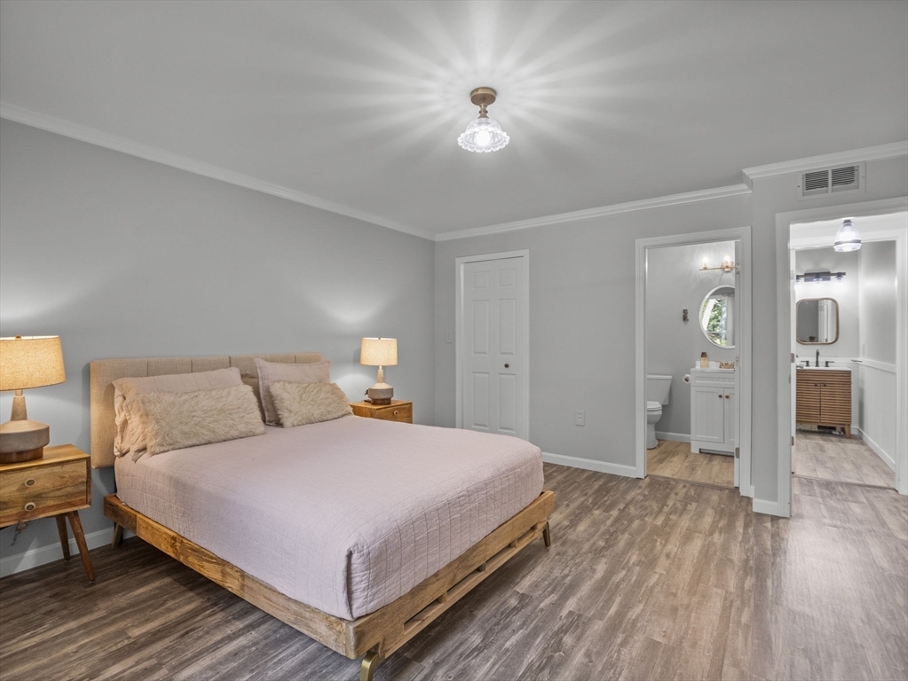 7 Shadowbrook Lane, Unit 9 Milford, MA 01757 - Photo 15 of 41 a bedroom with a bed and a chandelier