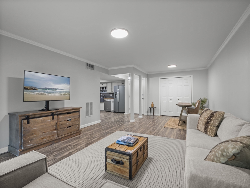 7 Shadowbrook Lane, Unit 9 Milford, MA 01757 - Photo 2 of 41 a living room with furniture and a flat screen tv