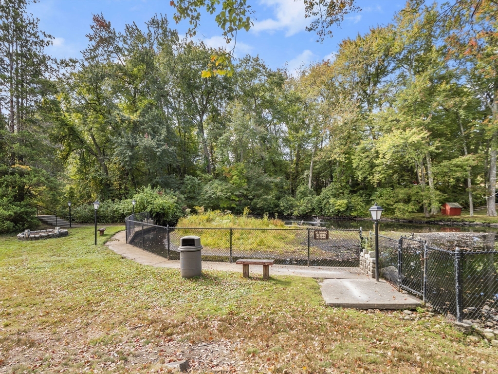 7 Shadowbrook Lane, Unit 9 Milford, MA 01757 - Photo 24 of 41 a view of a swimming pool with a bench and trees around