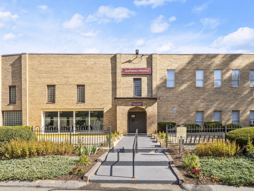 7 Shadowbrook Lane, Unit 9 Milford, MA 01757 - Photo 29 of 41 a front view of a house with a garden