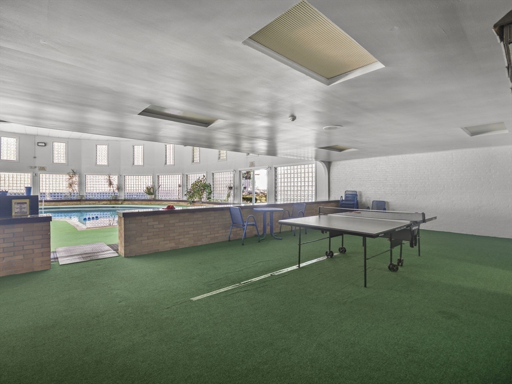 7 Shadowbrook Lane, Unit 9 Milford, MA 01757 - Photo 34 of 41 a room with kitchen island a table and chairs