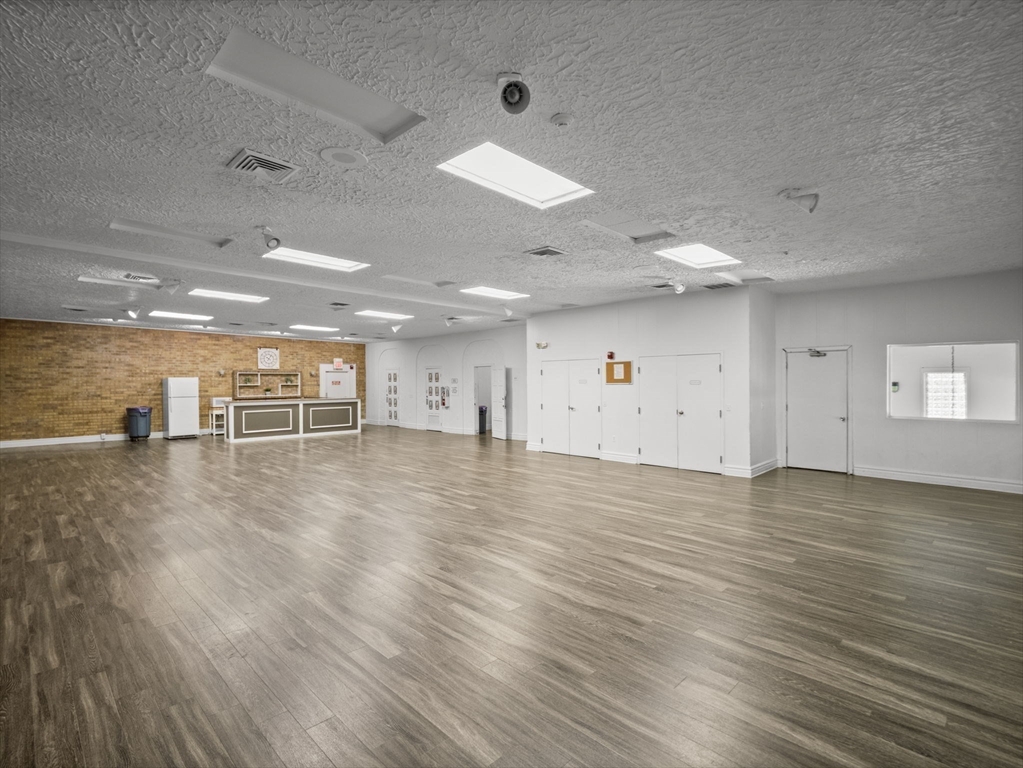 7 Shadowbrook Lane, Unit 9 Milford, MA 01757 - Photo 37 of 41 an empty room with wooden floor and windows