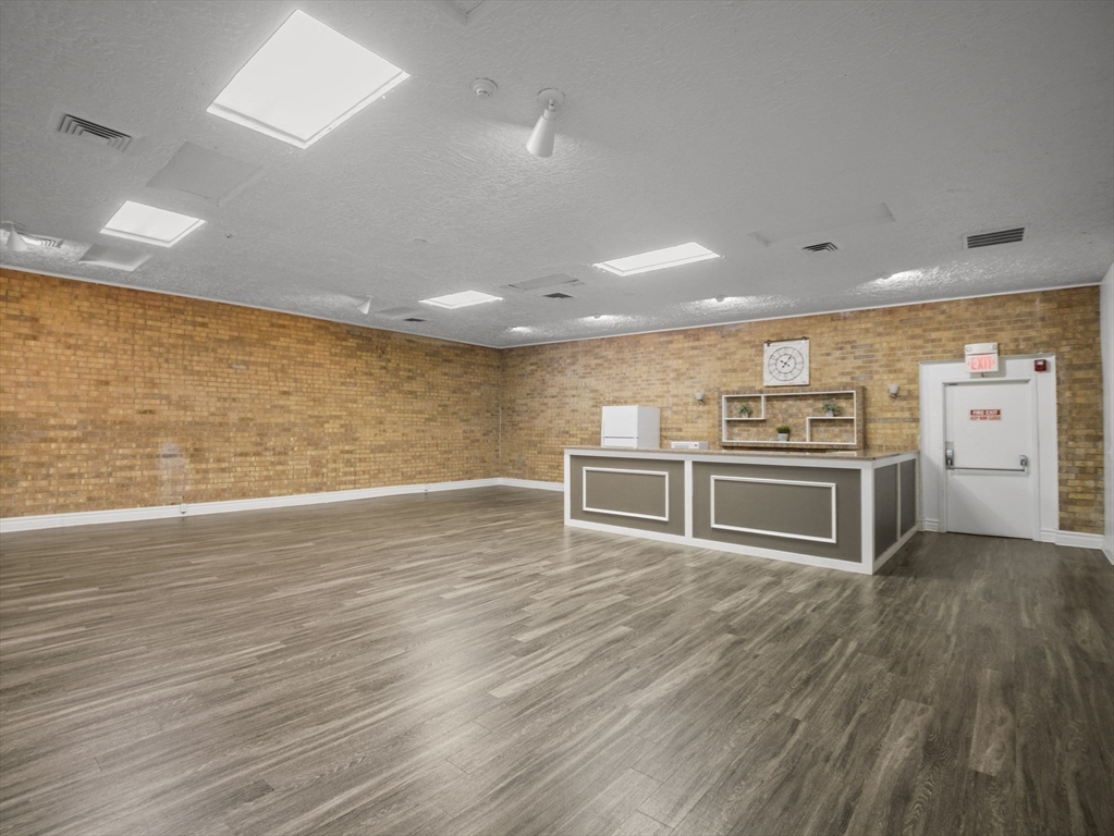 7 Shadowbrook Lane, Unit 9 Milford, MA 01757 - Photo 38 of 41 a view of a kitchen with stainless steel appliances wooden floor and living room