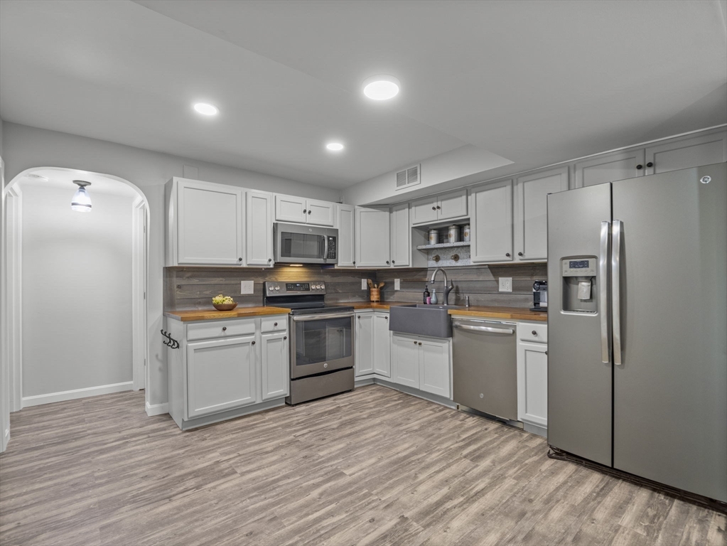 7 Shadowbrook Lane, Unit 9 Milford, MA 01757 - Photo 5 of 41 a kitchen with granite countertop a refrigerator stove top oven and sink