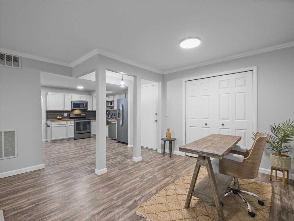 7 Shadowbrook Lane, Unit 9 Milford, MA 01757 - Photo 9 of 41 a living room with furniture and kitchen view