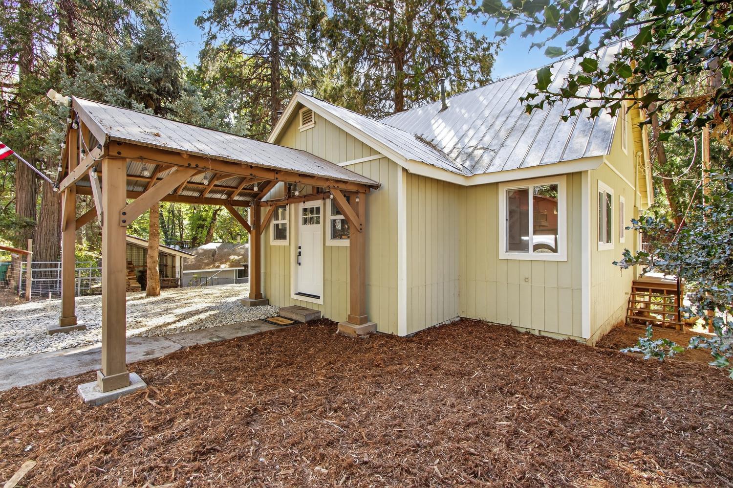 a view of a house with a small yard and floor to ceiling window