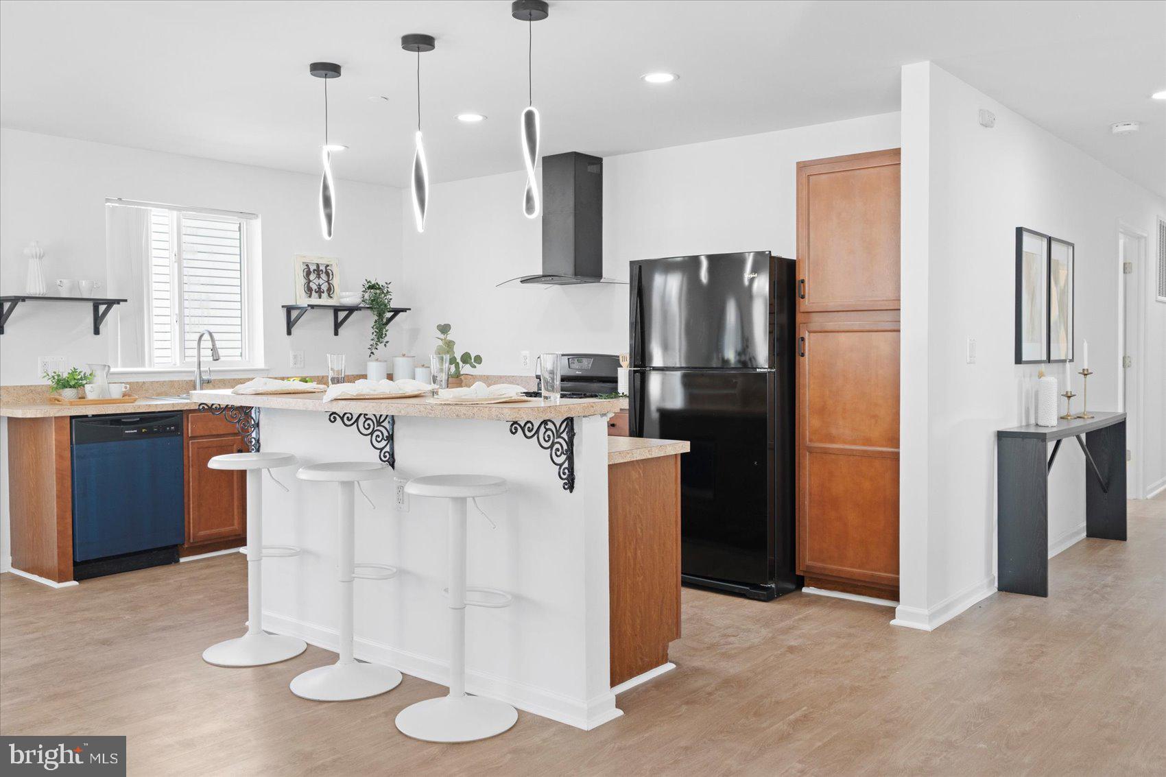 313 Homberg Avenue Baltimore, MD 21221 - Photo 11 of 47 a kitchen with stainless steel appliances kitchen island granite countertop a refrigerator a stove a sink and a microwave