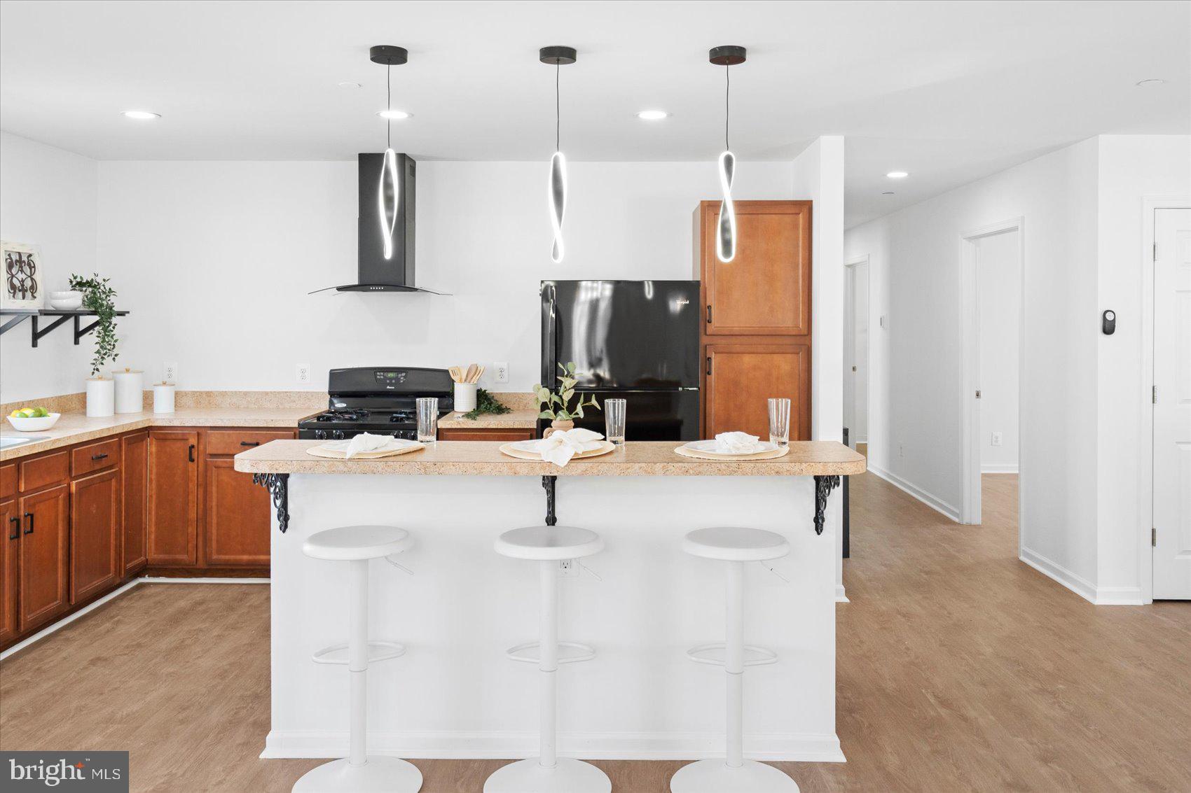313 Homberg Avenue Baltimore, MD 21221 - Photo 12 of 47 a kitchen with kitchen island a sink stainless steel appliances and cabinets