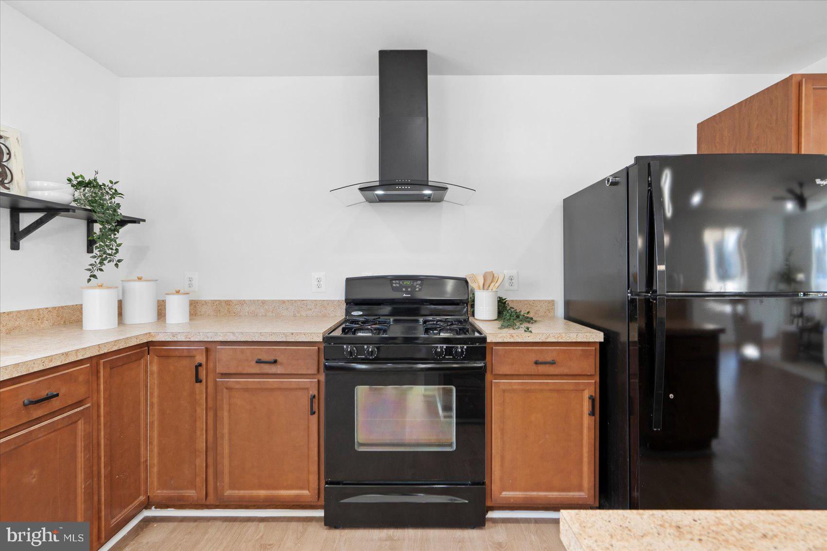 313 Homberg Avenue Baltimore, MD 21221 - Photo 16 of 47 a kitchen with stainless steel appliances granite countertop a stove and a refrigerator