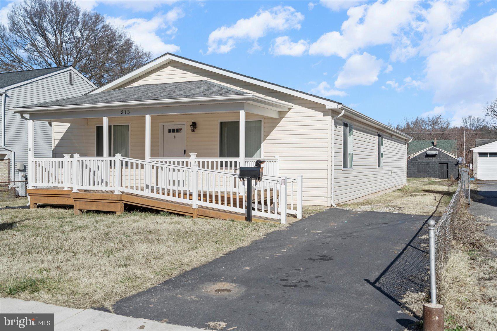 313 Homberg Avenue Baltimore, MD 21221 - Photo 2 of 47 a view of a house with a yard and wooden fence
