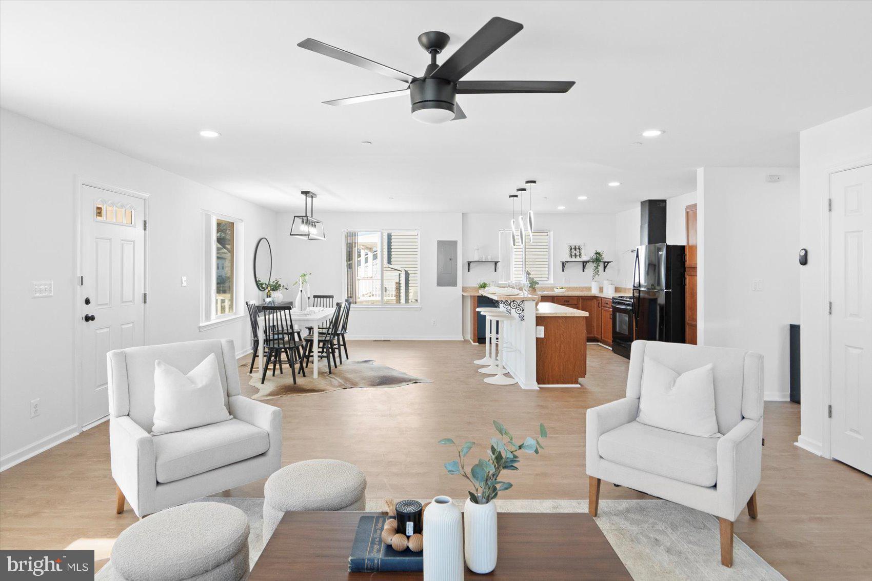 313 Homberg Avenue Baltimore, MD 21221 - Photo 25 of 47 a living room with furniture kitchen view and a chandelier